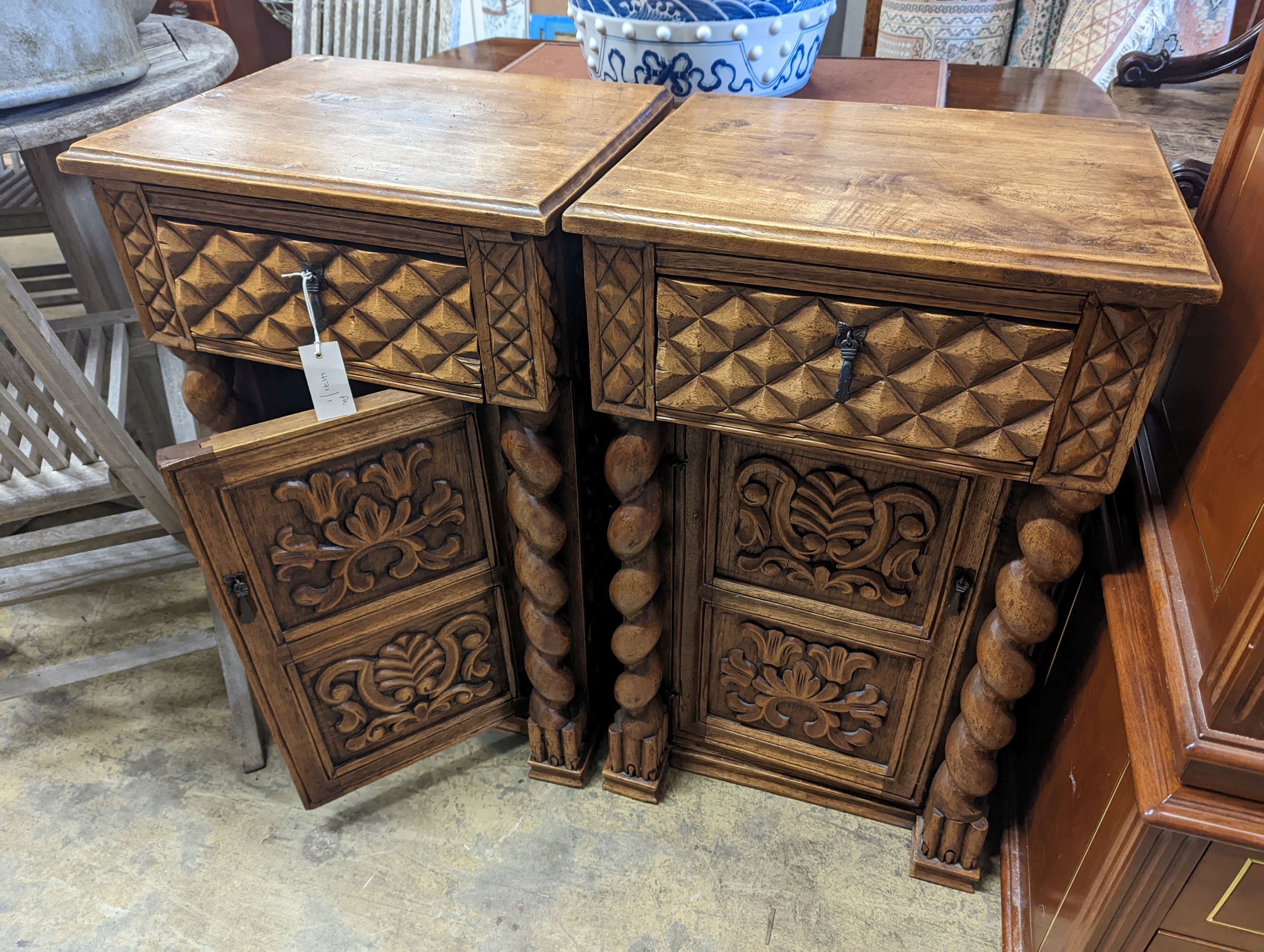 A pair of Spanish style carved walnut bedside cabinets, width 48cm, depth 38cm, height 79cm